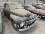 many old cars that are parked in a parking lot
