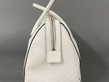 a close up of a white purse with a cross on it