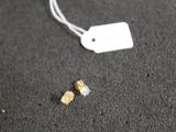 a small piece of paper on the ground next to a tag