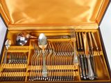a box with a bunch of forks and spoons inside of it