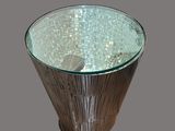 a glass table with a metal base and a glass top