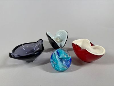 three different colored glass bowls sitting next to each other on a table