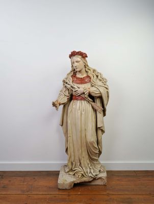 an old statue of a woman holding a baby in her arms