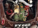 a very old car with a very nice engine in it