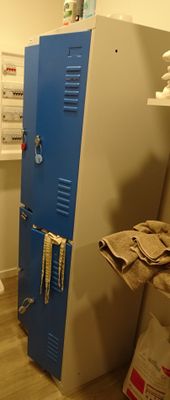 a blue locker in the corner of a room