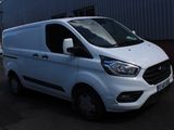 the white van is parked in front of a building