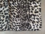 the black and white leopard print bag is on the floor