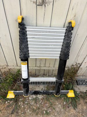 an image of a ladder leaning against a wall with a sign attached to it