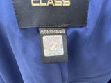 the label of a blue shirt with a black and gold logo on it