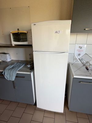 a refrigerator and a sink in a small kitchen