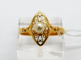 a close up of a gold ring with a pearl in it