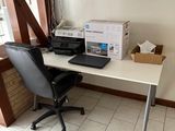 a desk with a laptop and a printer on it