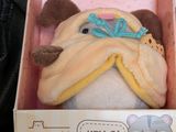 a stuffed animal that is in a box on the table