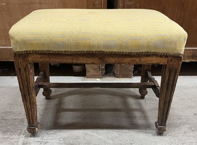 a small bench with a yellow upholstered seat