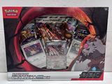 La boîte contient un assortiment de cartes Pokémon et un stylo.