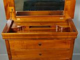 an old wooden dresser with a mirror on top of it