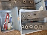 a metal box with tools inside of it on the floor