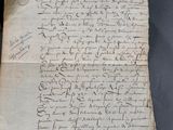 an old piece of paper with writing on it sitting on top of a table