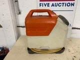 an orange and white gas can sitting on top of a table