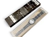 a black and white watch in a box next to a black and white watch
