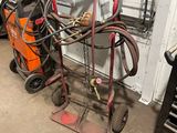 a cart with a hose attached to it in a garage