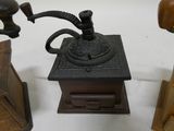a small coffee grinder sitting on a table next to other items
