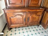 a wooden cabinet in the corner of a room