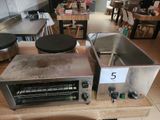 an image of a counter top with a toaster and a pan on it
