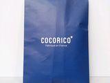 a blue paper bag with the word cocorico on it