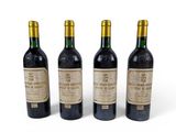 three bottles of wine sitting next to each other on a white surface