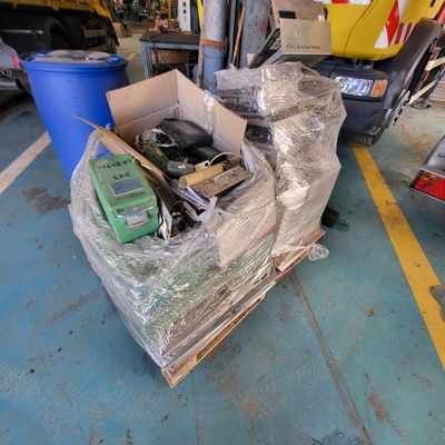 a box of assorted items on the floor of a garage