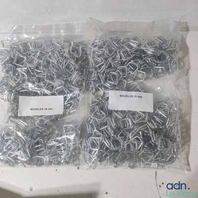 two bags of screws and a bag of nails on a table