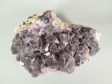 a close up of a piece of rock with purple crystals on it
