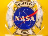yellow nasa helmet with nasa emblem on the side of it
