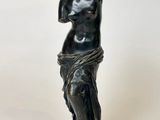 an image of a statue of a woman on a marble base
