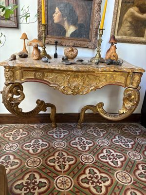 a table with a mirror and a candle on it