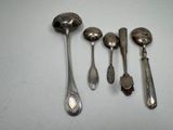 five spoons and two spoons sitting on a table