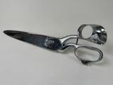 a pair of scissors sitting on a white surface