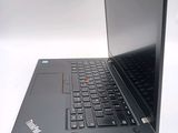 a laptop that is open on a white surface