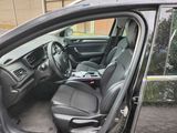 the interior of a car with the door open showing the driver ' s seat