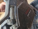 a person using a circular saw to cut a piece of wood