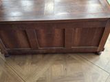 a wooden chest sitting on the floor in a room