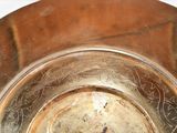a close up of a metal bowl on a table