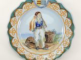 a decorative plate with a picture of a woman carrying a basket