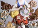 a figurine of a woman sitting on top of a table