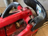 a chainsaw sitting on the floor next to a window