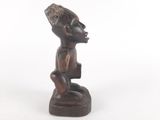 an old wooden figurine of a man with a hat on his head