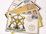 a picture of a collection of postcards and stamps on a table