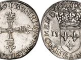 a silver coin with a cross and a crown on it