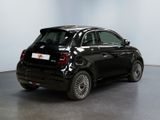 the small black car is parked in a large room